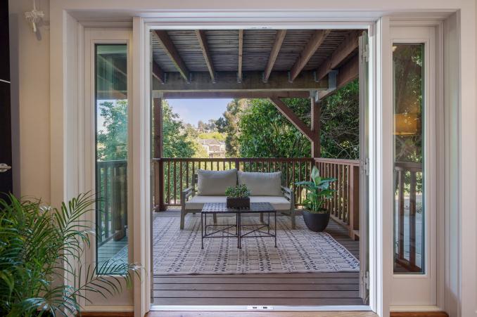 Property Thumbnail: An outdoor couch as seen through open glass doors
