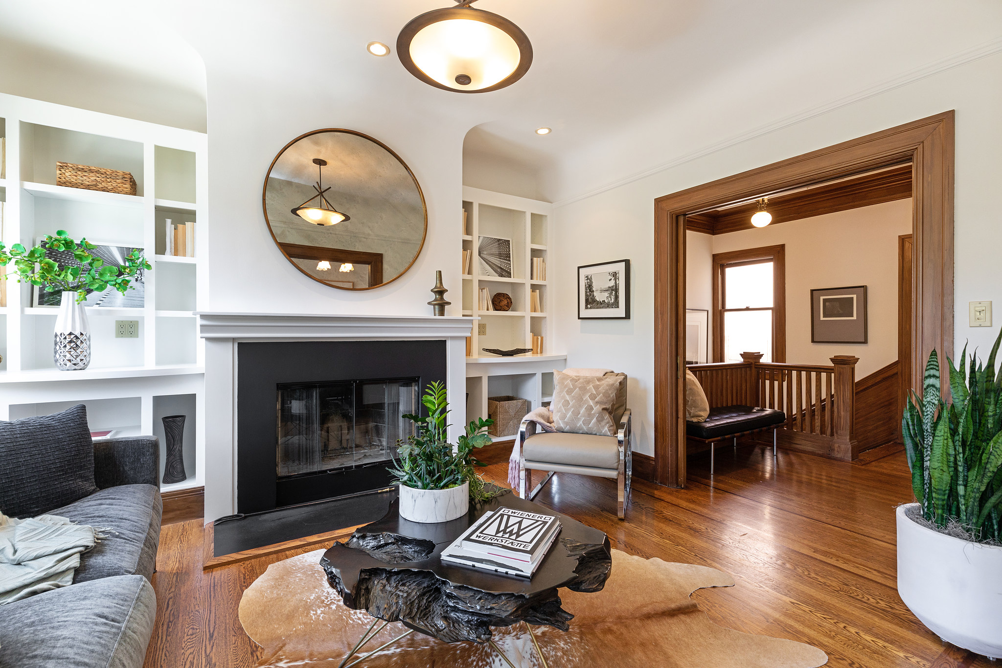 Property Photo: View of the living room at 38 Parnassus Avenue, featuring a fireplace from black facade and white mantle 