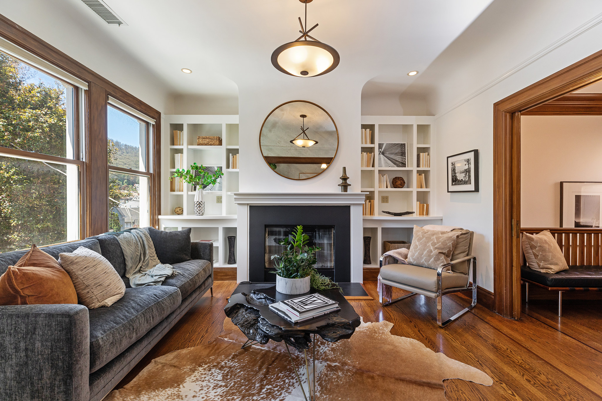 Property Photo: View of the living room, featuring wood floors and a fireplace
