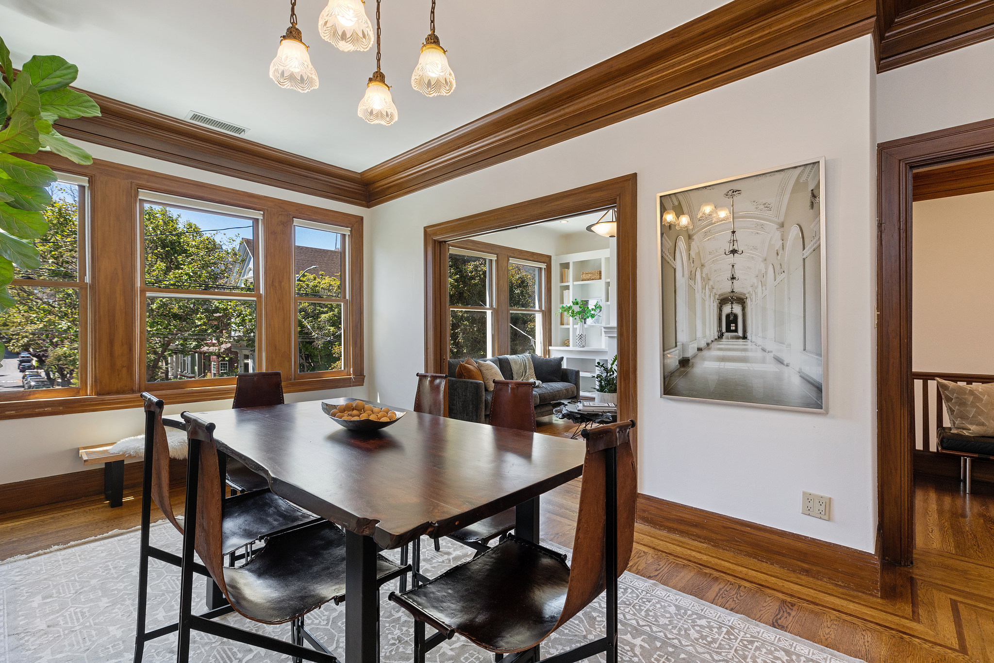 Property Photo: Dining room, showing three large windows and entrance into the living room