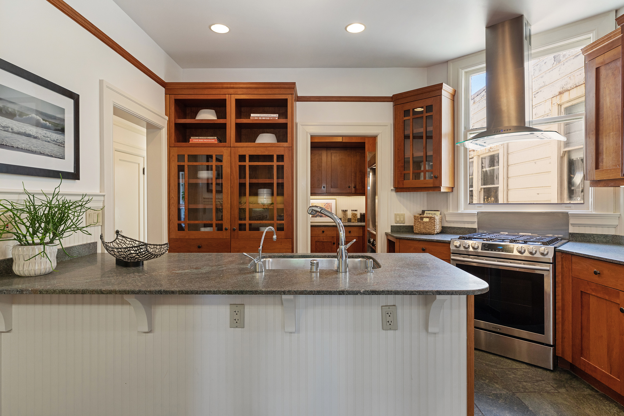 Property Photo: View of the kitchen, showing an island cabinet with sink