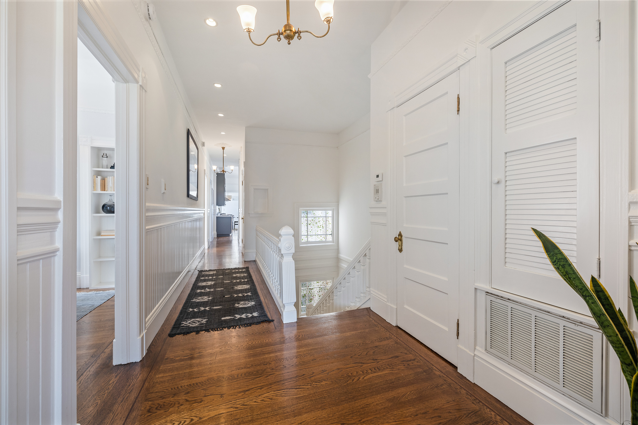 Property Photo: Hallway with wood floors and white walls