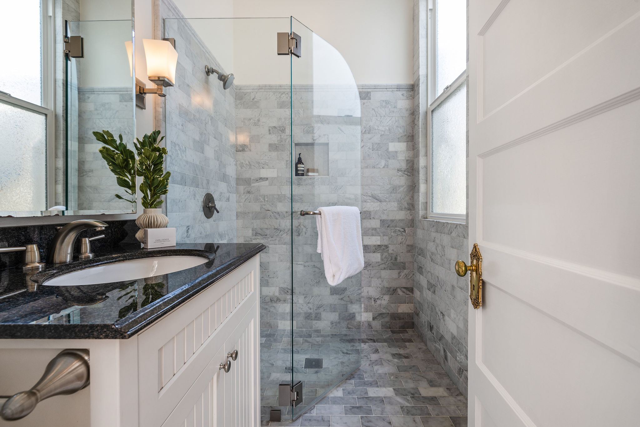 Property Photo: Bathroom, featuring a glass a glass shower with light grey tile
