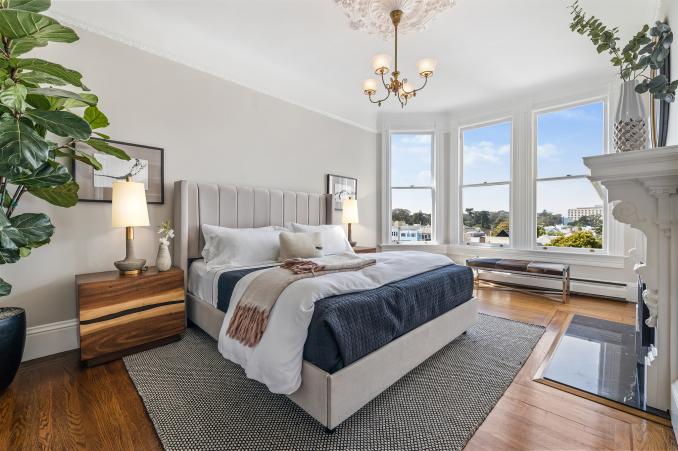 Property Thumbnail: View of primary bedroom with large bay windows and wood floor
