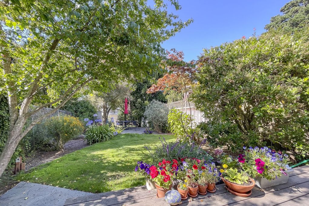 Property Photo: Exterior view of the lush out door space, featuring flowers and trees