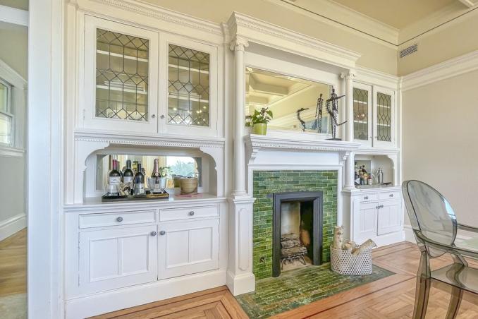 Property Thumbnail: Formal dining room with fireplace, featuring green tile and white mantle