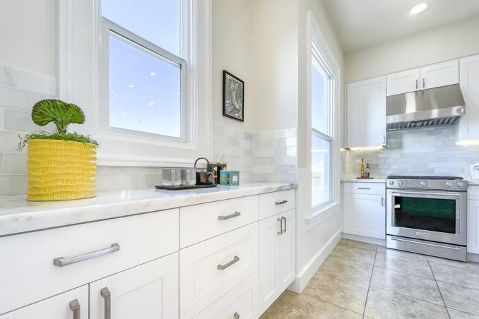 Property Thumbnail: White cabinets and tile floors found in the kitchen at 1356 Waller Street