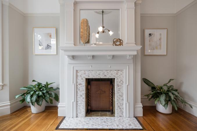 Property Thumbnail: Up-close view of a tiled fireplace with white wood