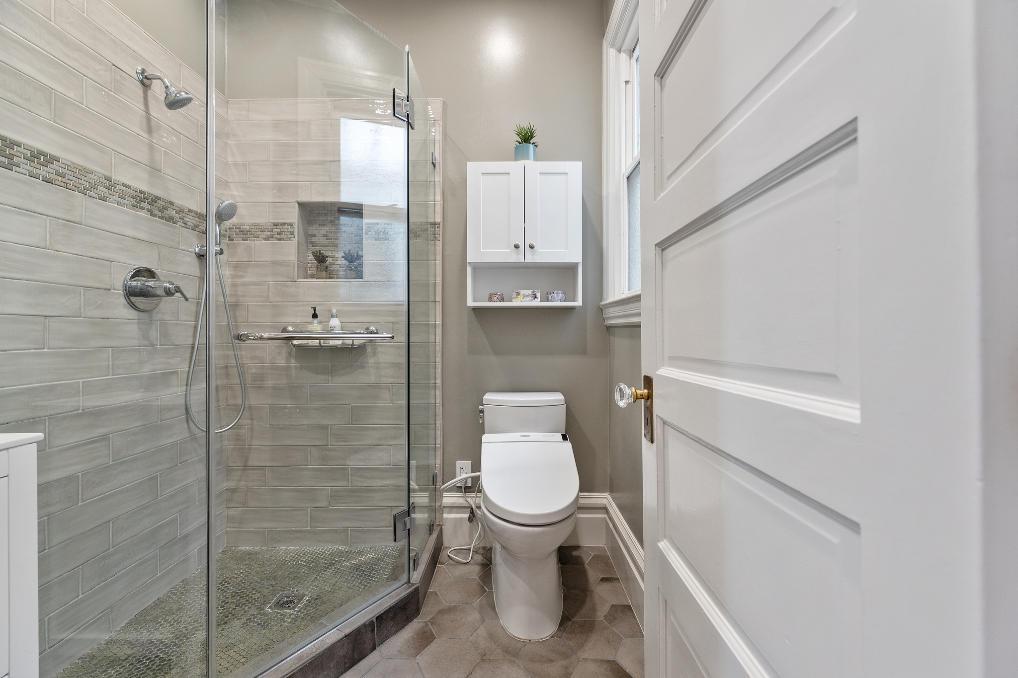 Property Photo: A glass shower and entry-way to a bathroom
