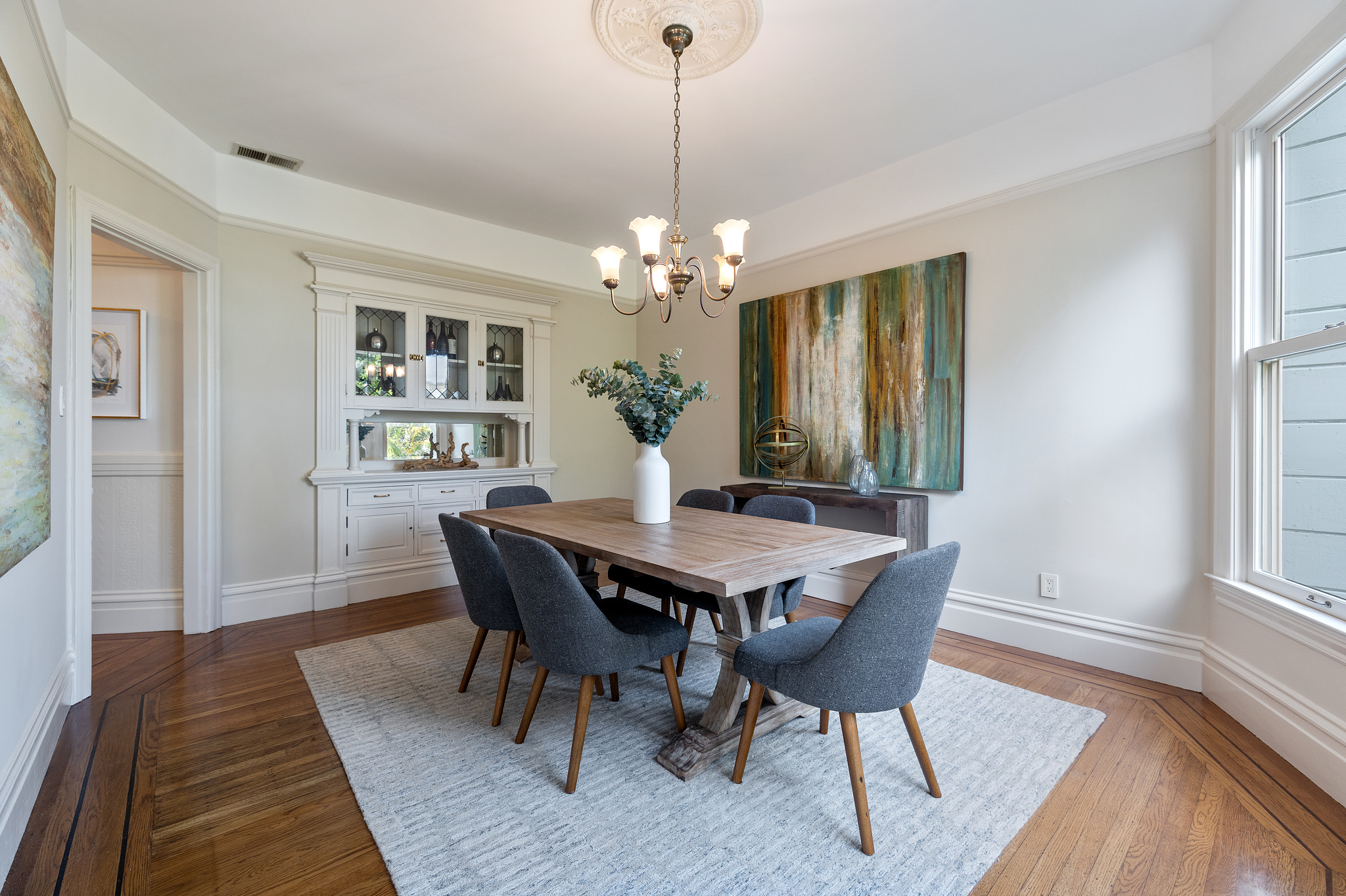 Property Photo: View of the dining room from the window, looking towards a large built-in cabinet