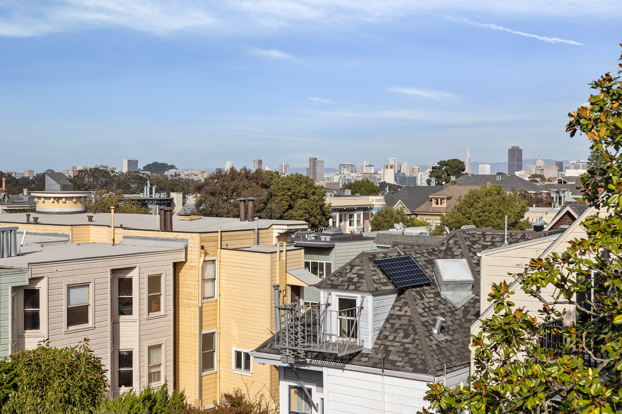Property Photo: Cheery roof-tops and a blue sky is featured with a view of city