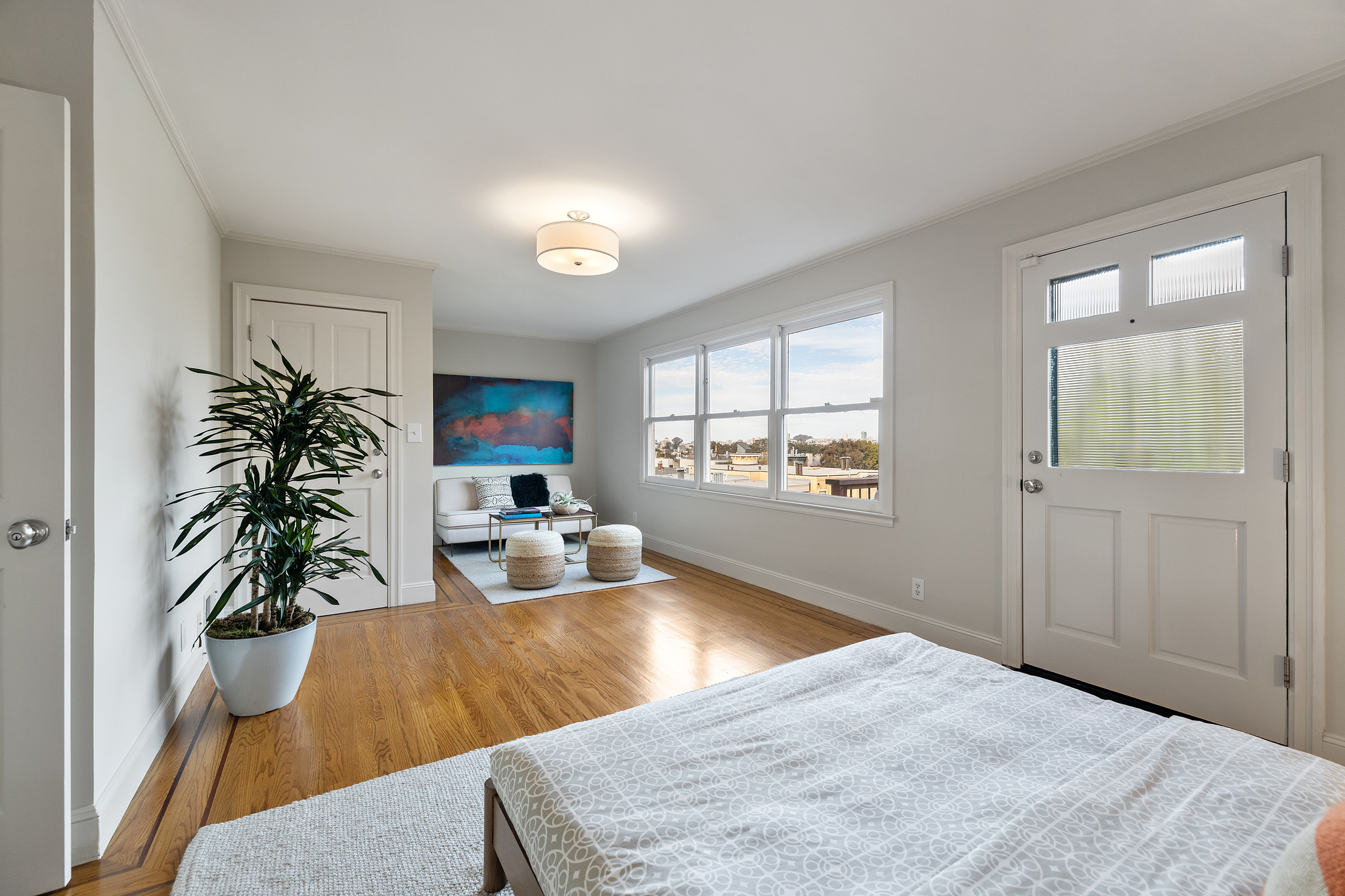 Property Photo: Long-view of a bedroom with seating area and deck access 