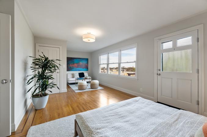 Property Thumbnail: Long-view of a bedroom with seating area and deck access 