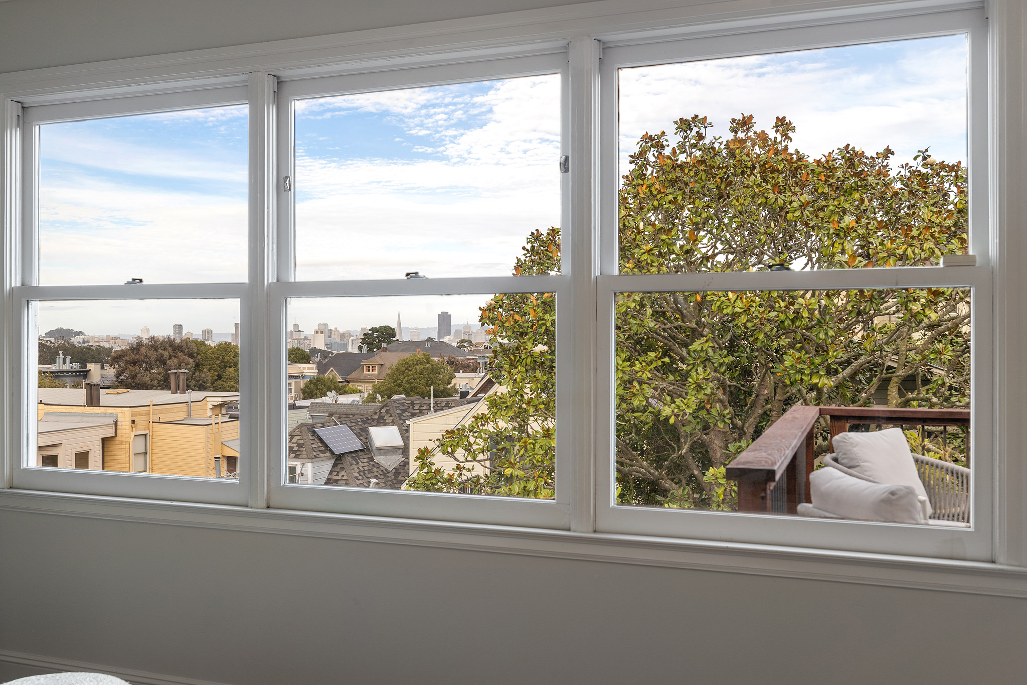 Property Photo: Three large windows provide sweeping views of San Francisco