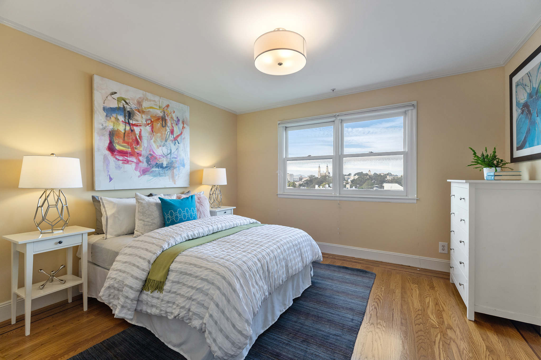 Property Photo: A yellow bedroom with two large windows