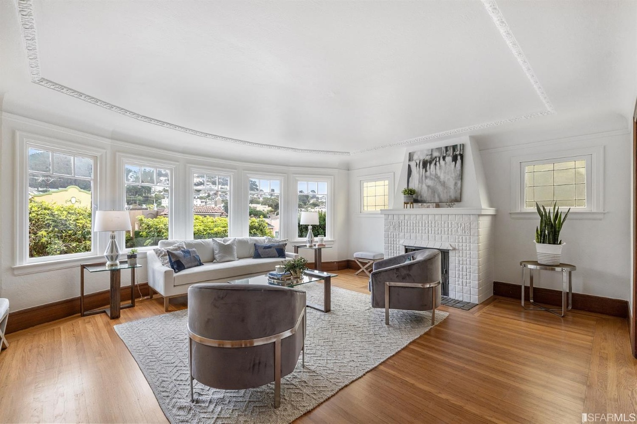 Property Photo: Living room at 78 Wawona Street, featuring white walls, white fireplace, and large windows
