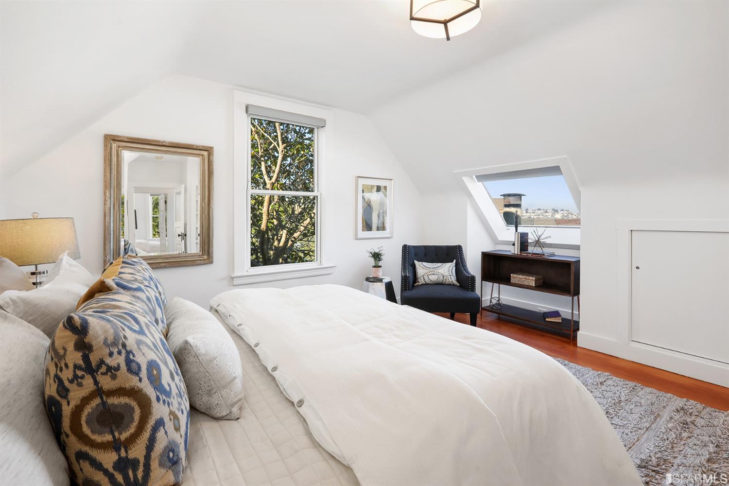 Property Photo: View of a bedroom with a skylight and sloped ceilings