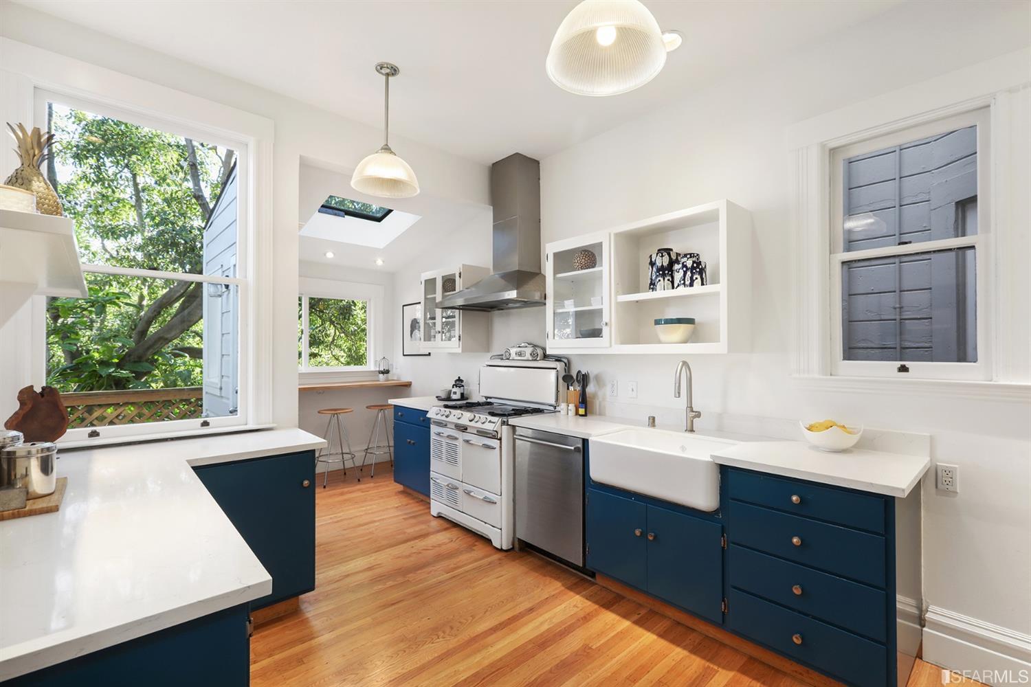 Property Photo: Kitchen, featuring wood floors and large windows