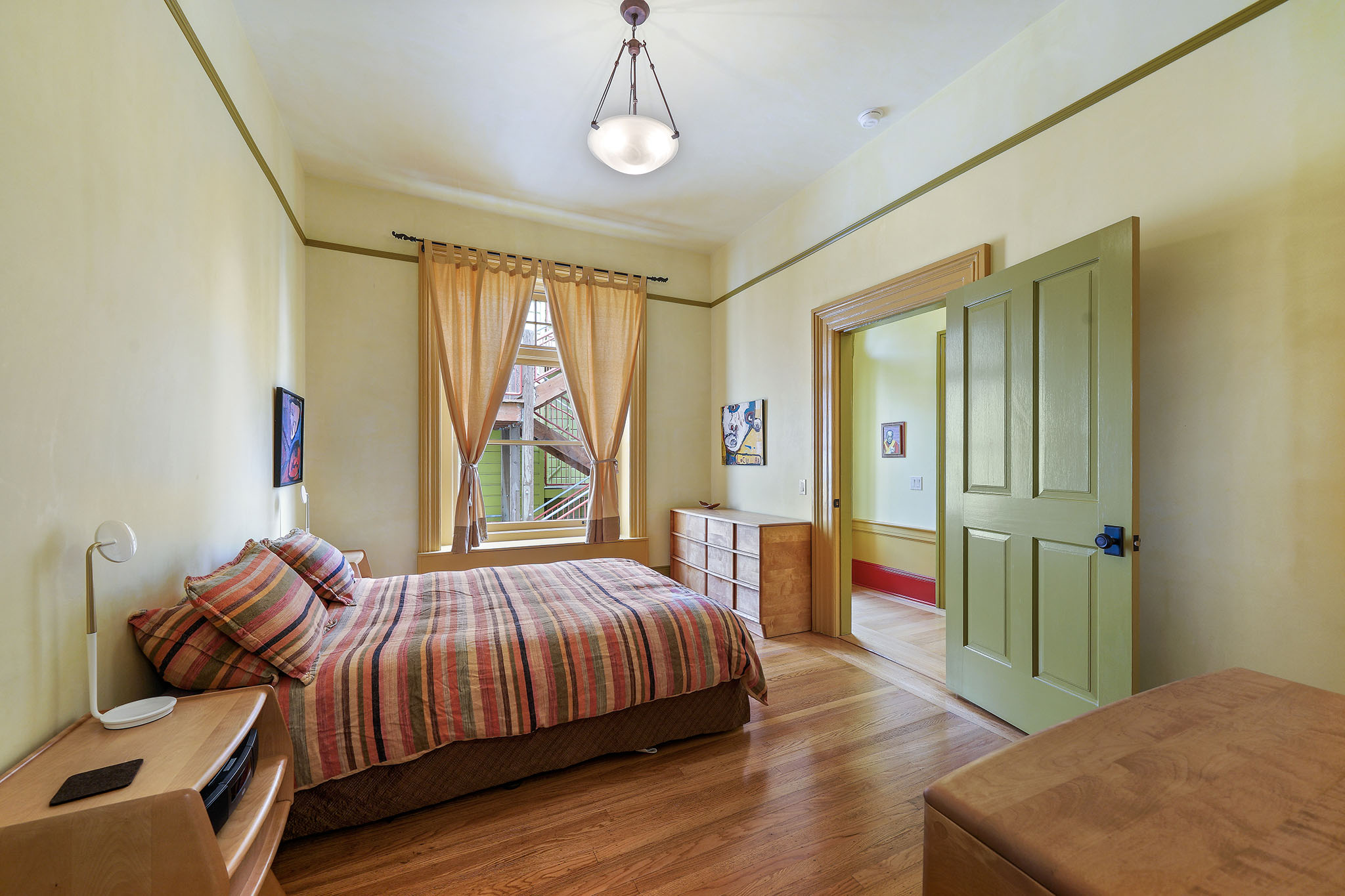 Property Photo: Bedroom with large windows and wide wood trim