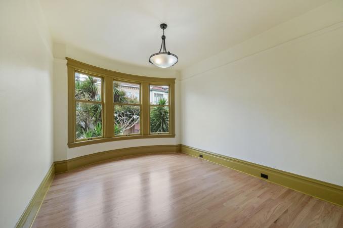 Property Thumbnail: View of an unfurnished room, featuring wood floors and large windows