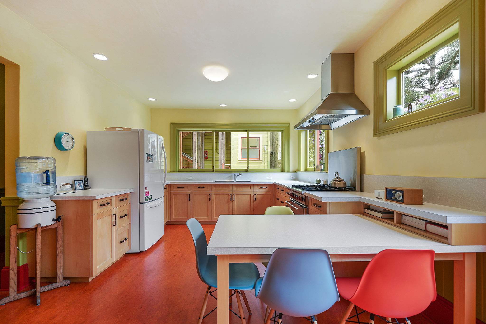 Property Photo: Kitchen, featuring large windows and wood cabinets