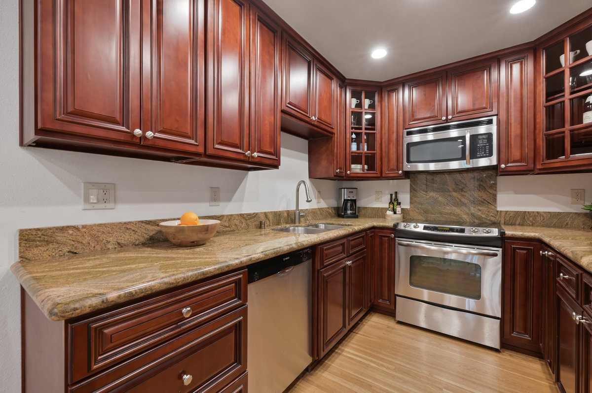 Property Photo: Lower unit kitchen, with dark wood counters