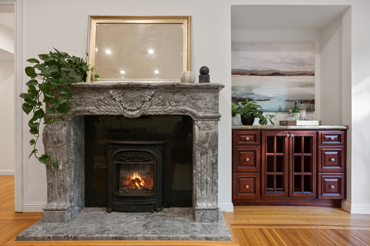 Property Photo: Close-up of a fireplace with grey mantle