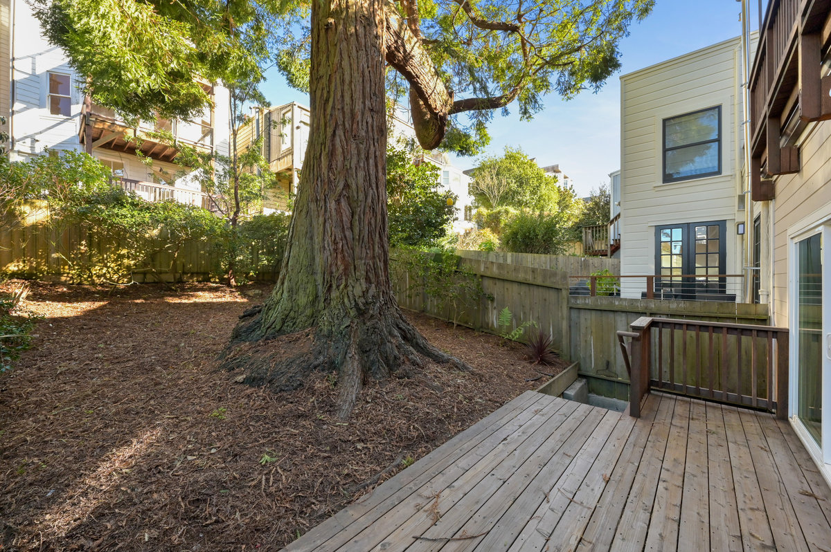 Property Photo: View of the back yard, showing the lower deck
