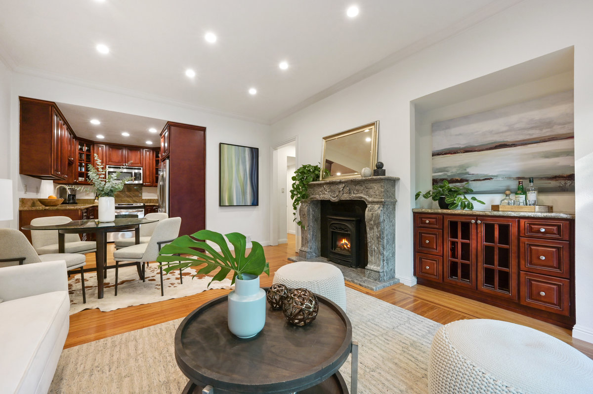 Property Photo: Lower unit living area with fireplace and wood floors