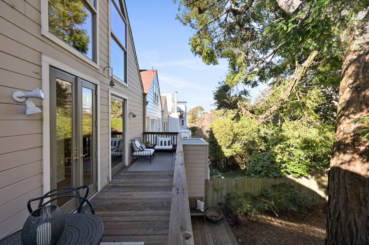 Property Photo: View of the upper deck, showing two outdoor seating areas