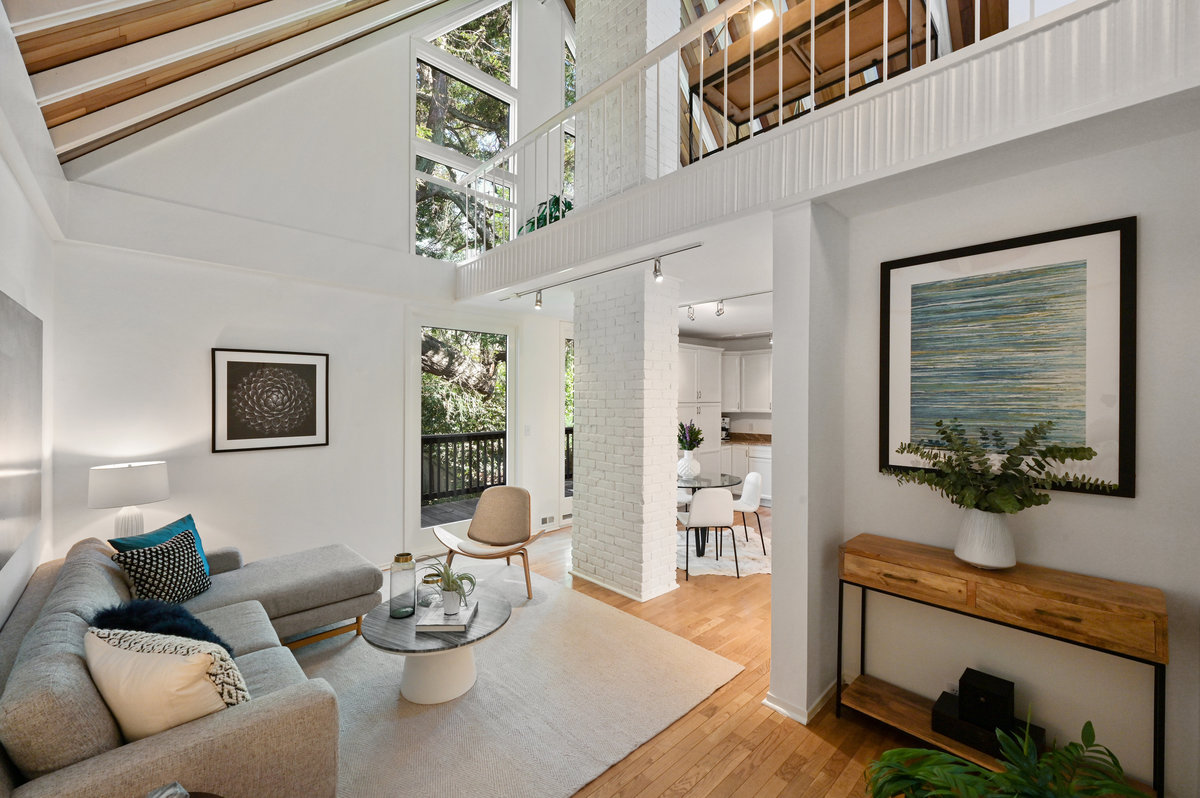 Property Photo: Living room, showing open ceilings to the second floor