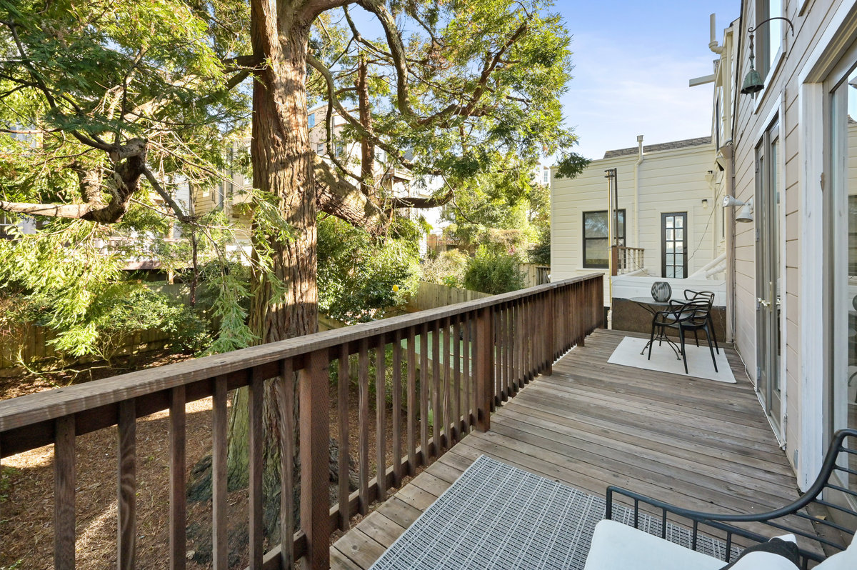 Property Photo: Long-view of the upper deck, showing a large tree