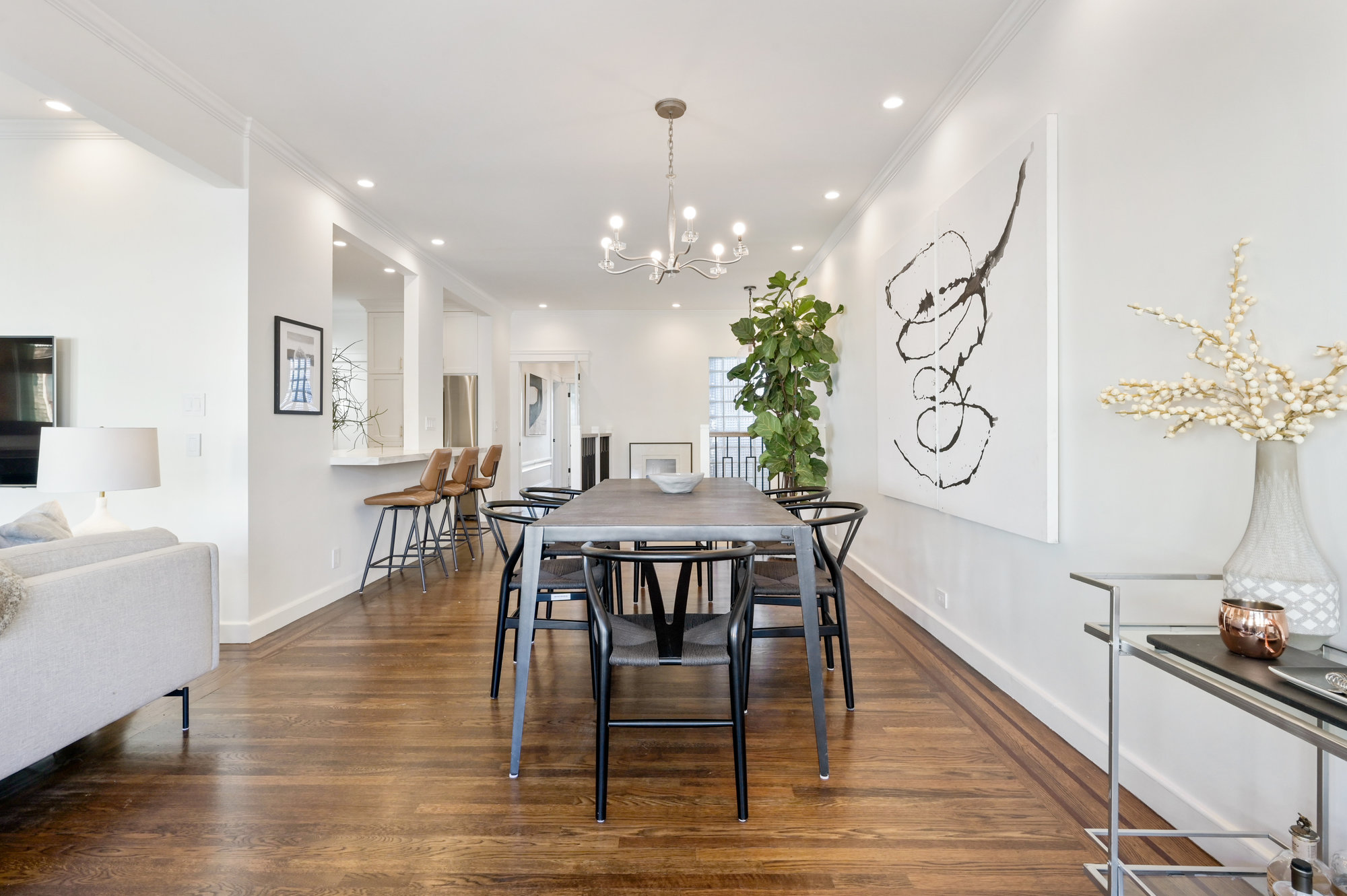 Property Photo: View of the dining area, featuring tall ceilings and wood floors