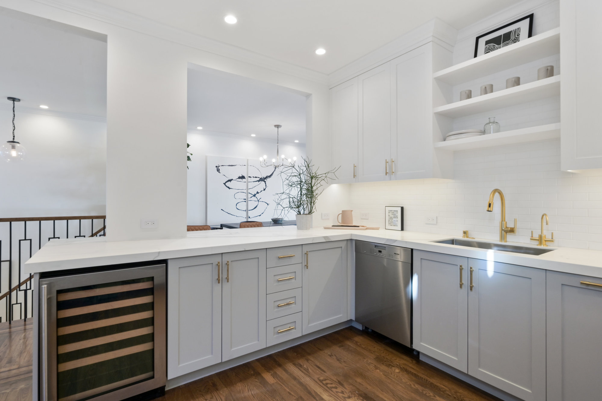 Property Photo: View of the kitchen cabinets, featuring a wine cooler
