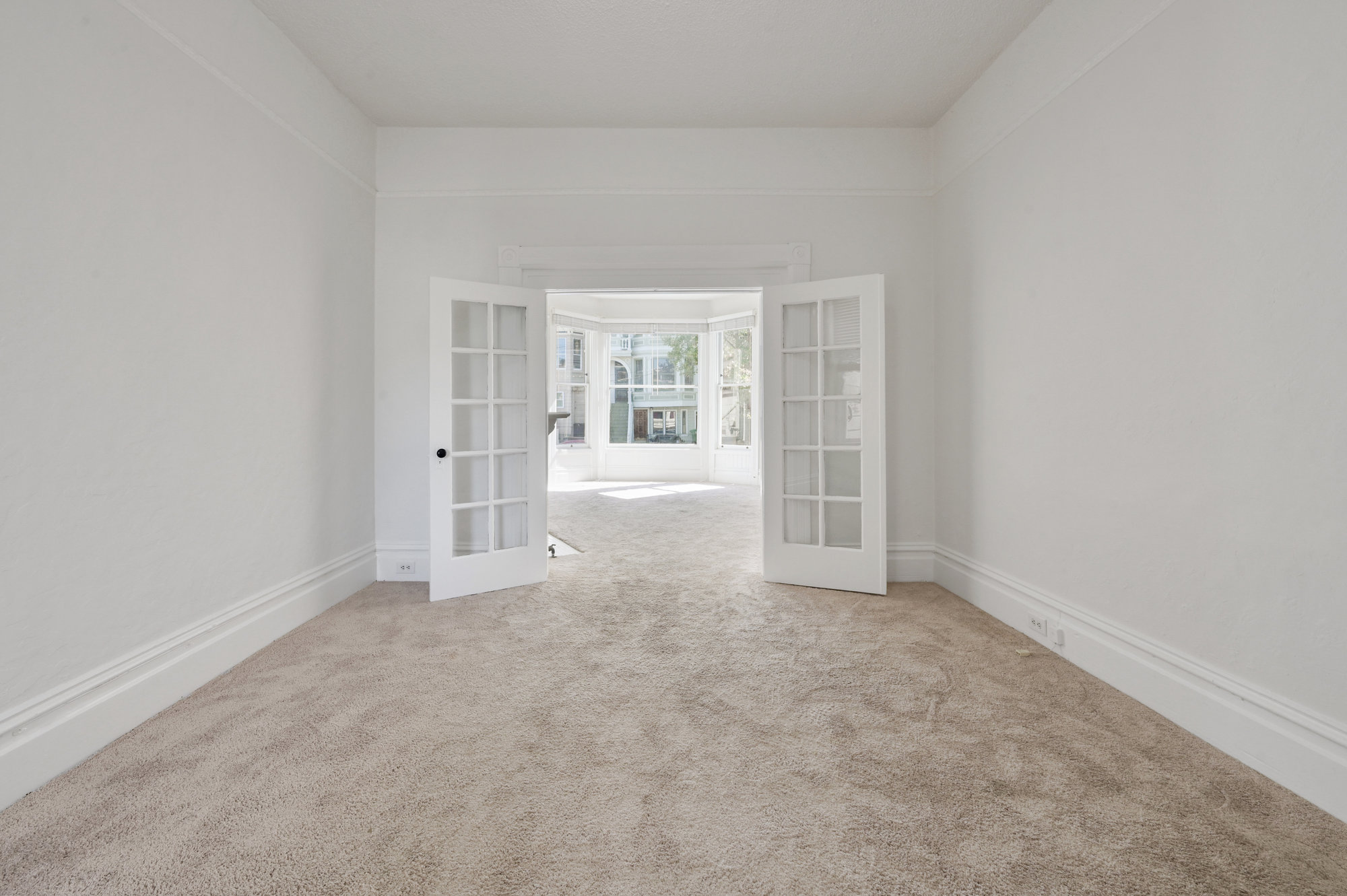 Property Photo: Long view of a living area, featuring french doors