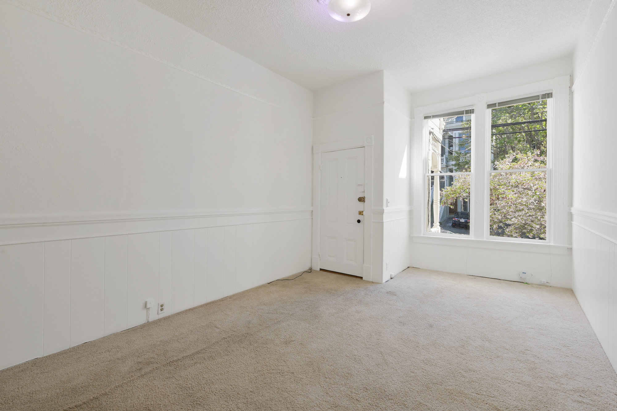 Property Photo: View of a room with carpet and two large windows