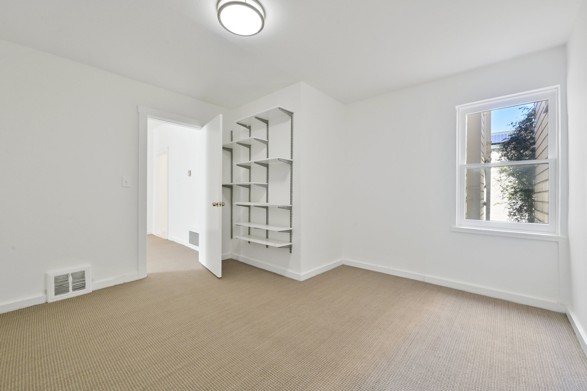 Property Photo: View of a room with white shelving 