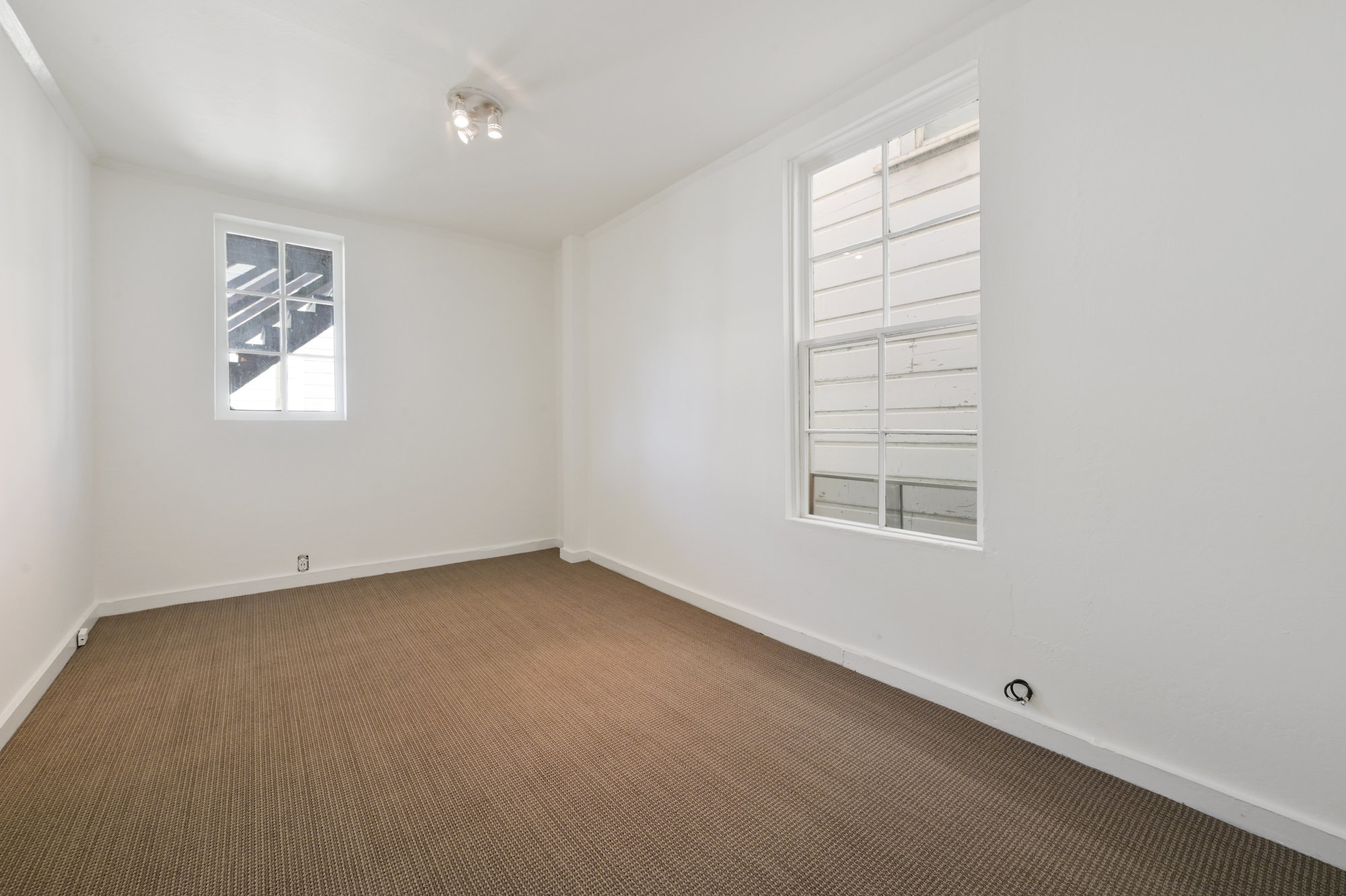 Property Photo: View of a long room with carpeting and two large windows