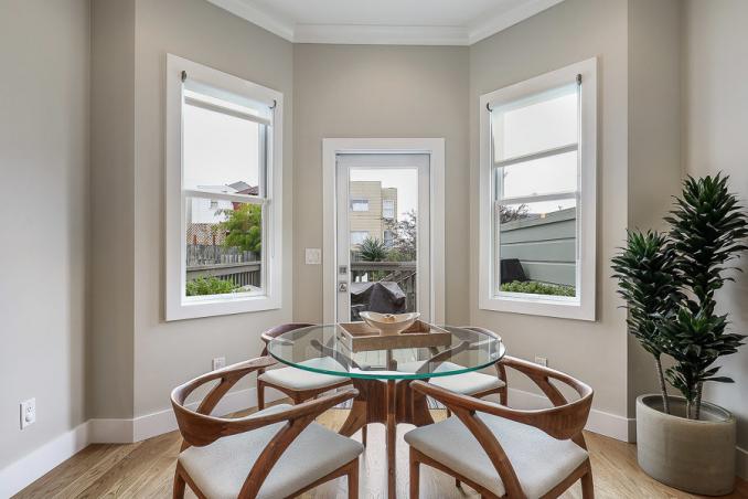 Property Thumbnail: Close-up of the dining area, featuring two large windows and an exterior door