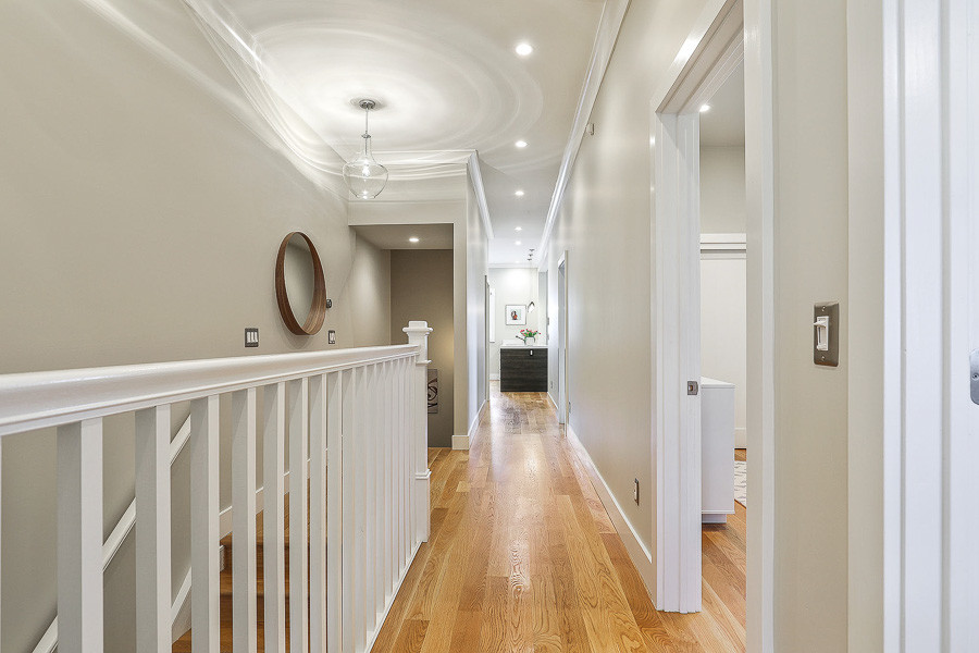 Property Photo: Hallway, featuring wood floors 