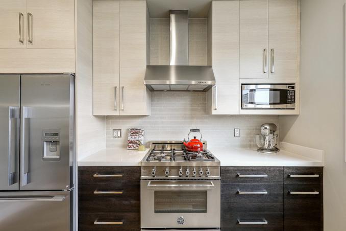Property Thumbnail: Close-up of the kitchen, featuring a stainless steel stove and fridge