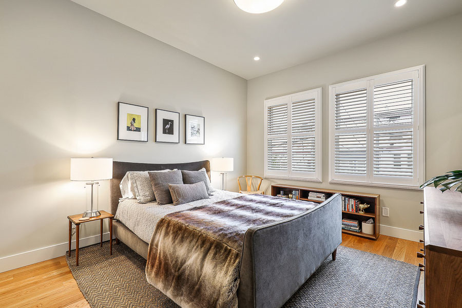 Property Photo: View of a large bedroom with two windows and wood floors