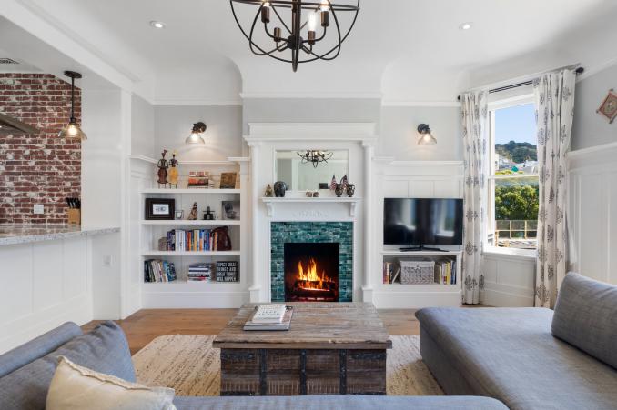 Property Thumbnail: View of the living room at 1473 Waller Street, showing a fireplace with tile surround