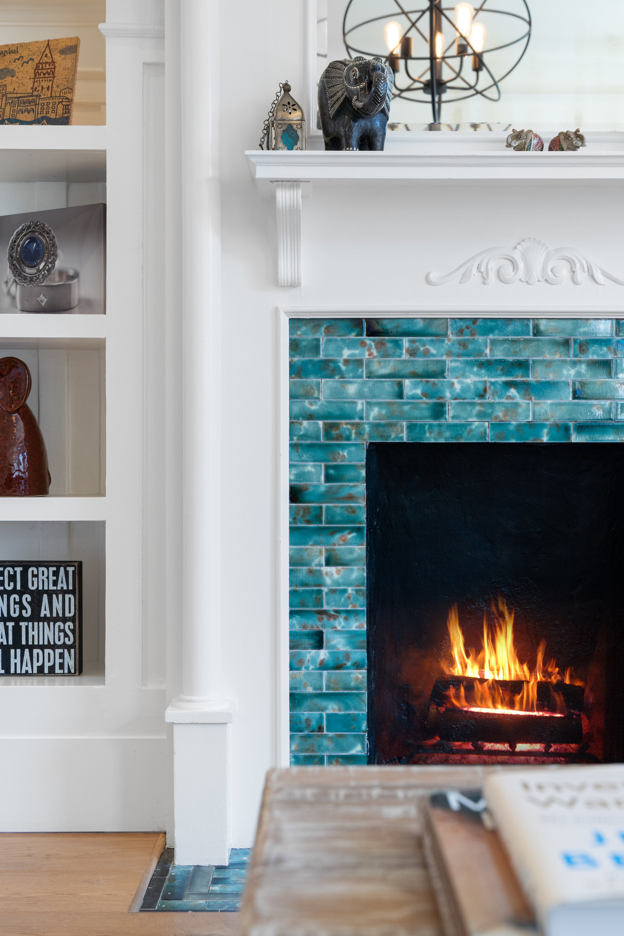 Property Photo: Close-up view of the turquoise tile and wood mantle surrounding the fireplace