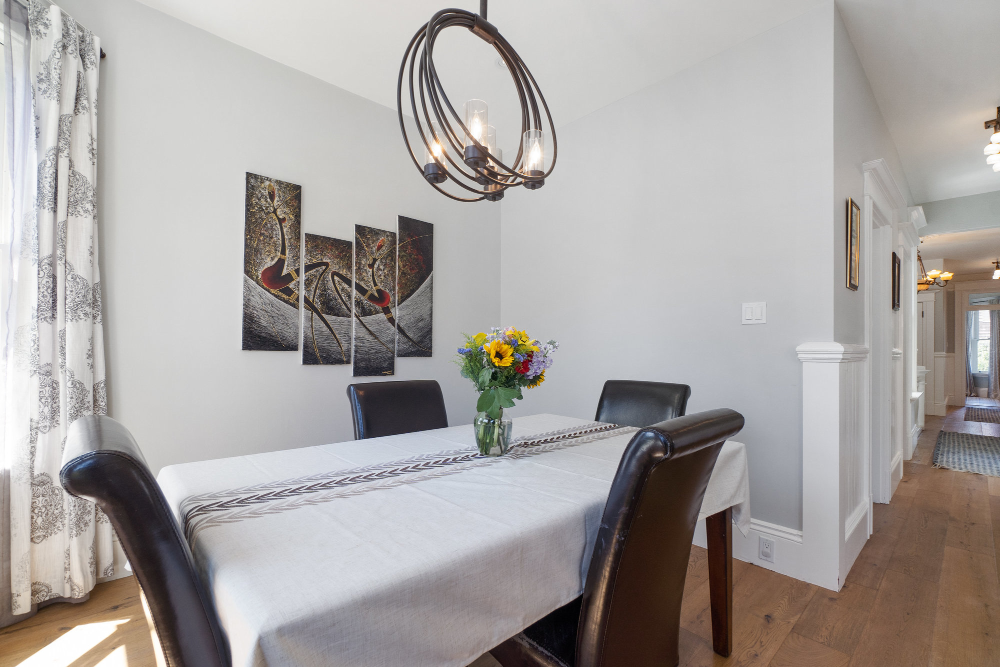 Property Photo: Formal dining area with modern light fixture 