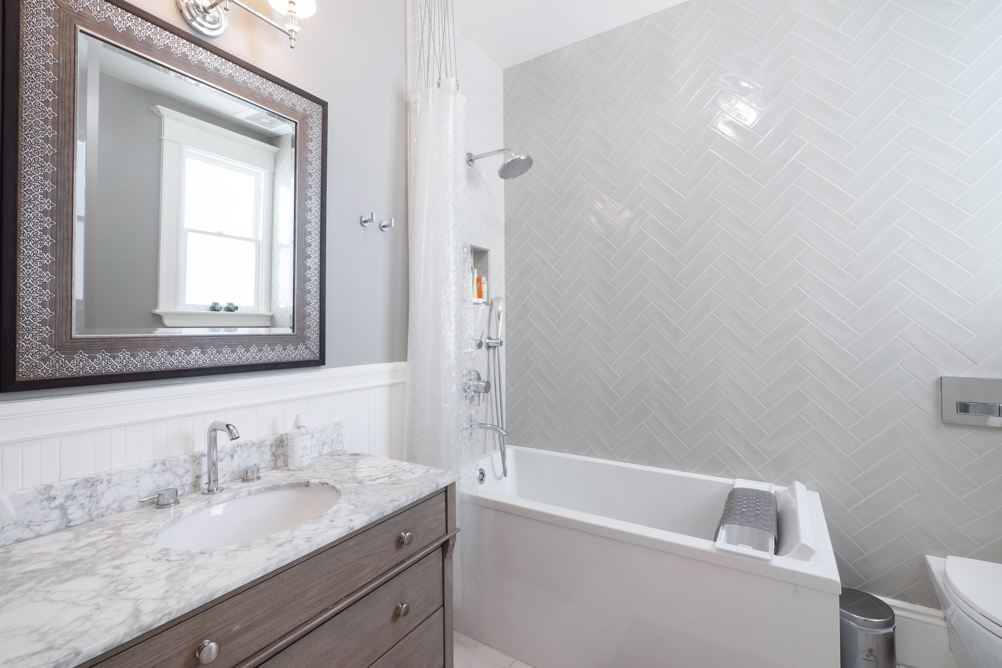 Property Photo: Bathroom with large soaking tub and lux wall tiling 