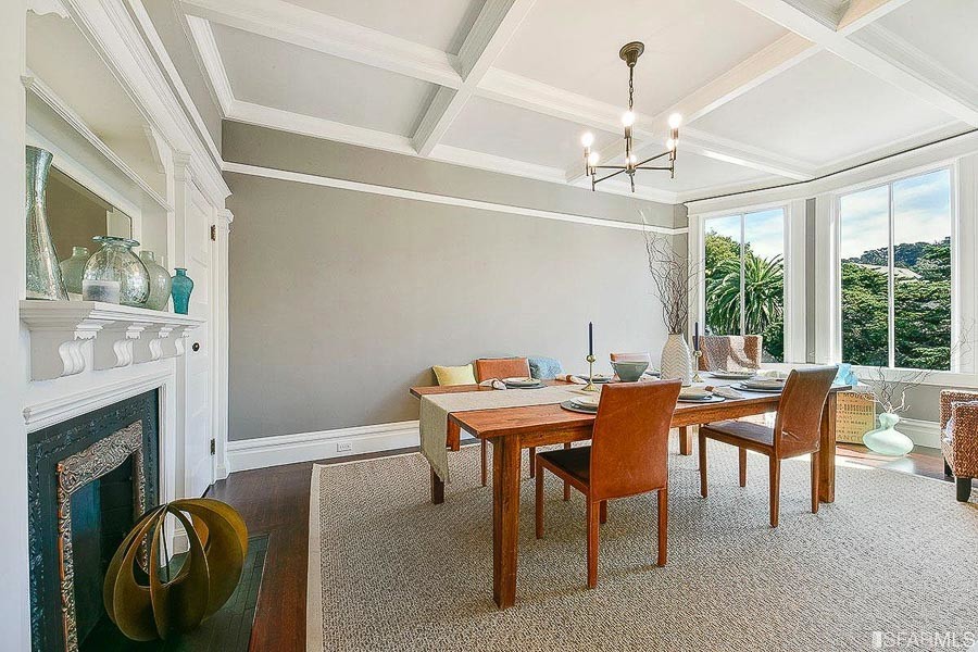 Property Photo: View of a formal dining room, featuring boxed ceilings and large windows