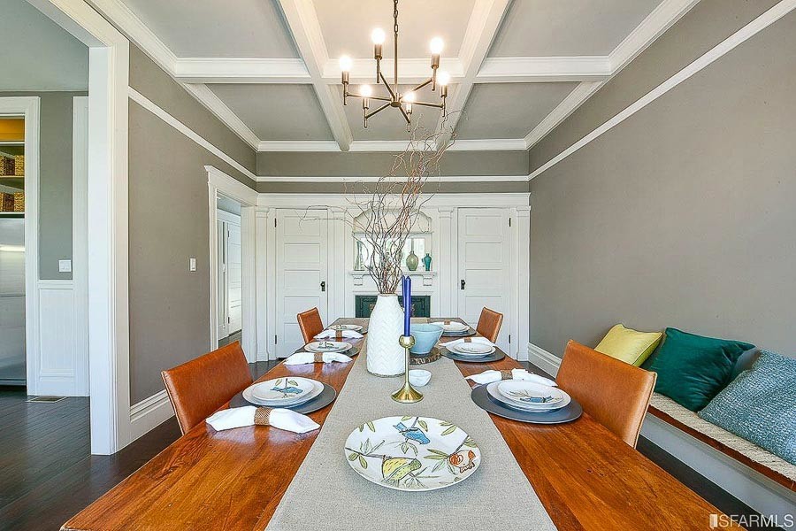 Property Photo: Formal dining room, featuring a fireplace and built-in cabinets at one end