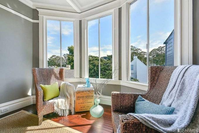 Property Thumbnail: Close-up of a brightly-lit sitting area near a set of large windows
