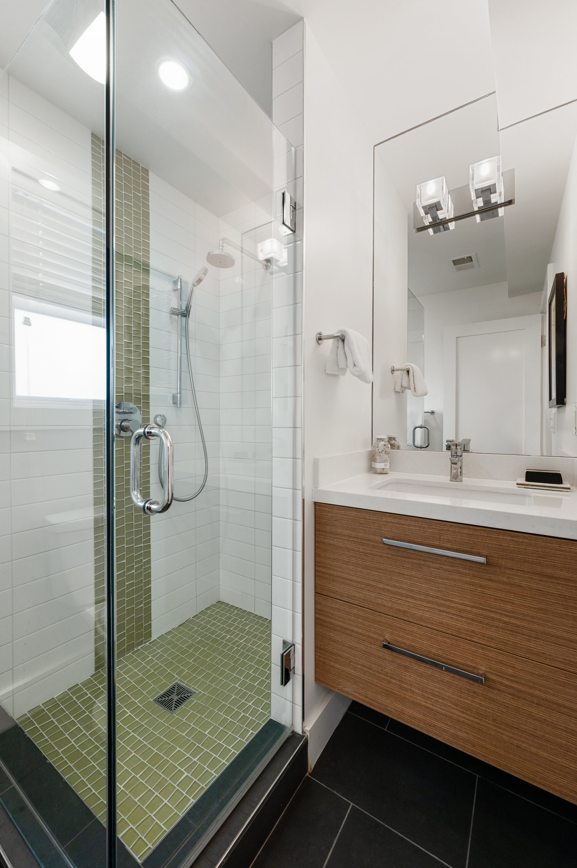 Property Photo: View of a bathroom with glass shower and vanity
